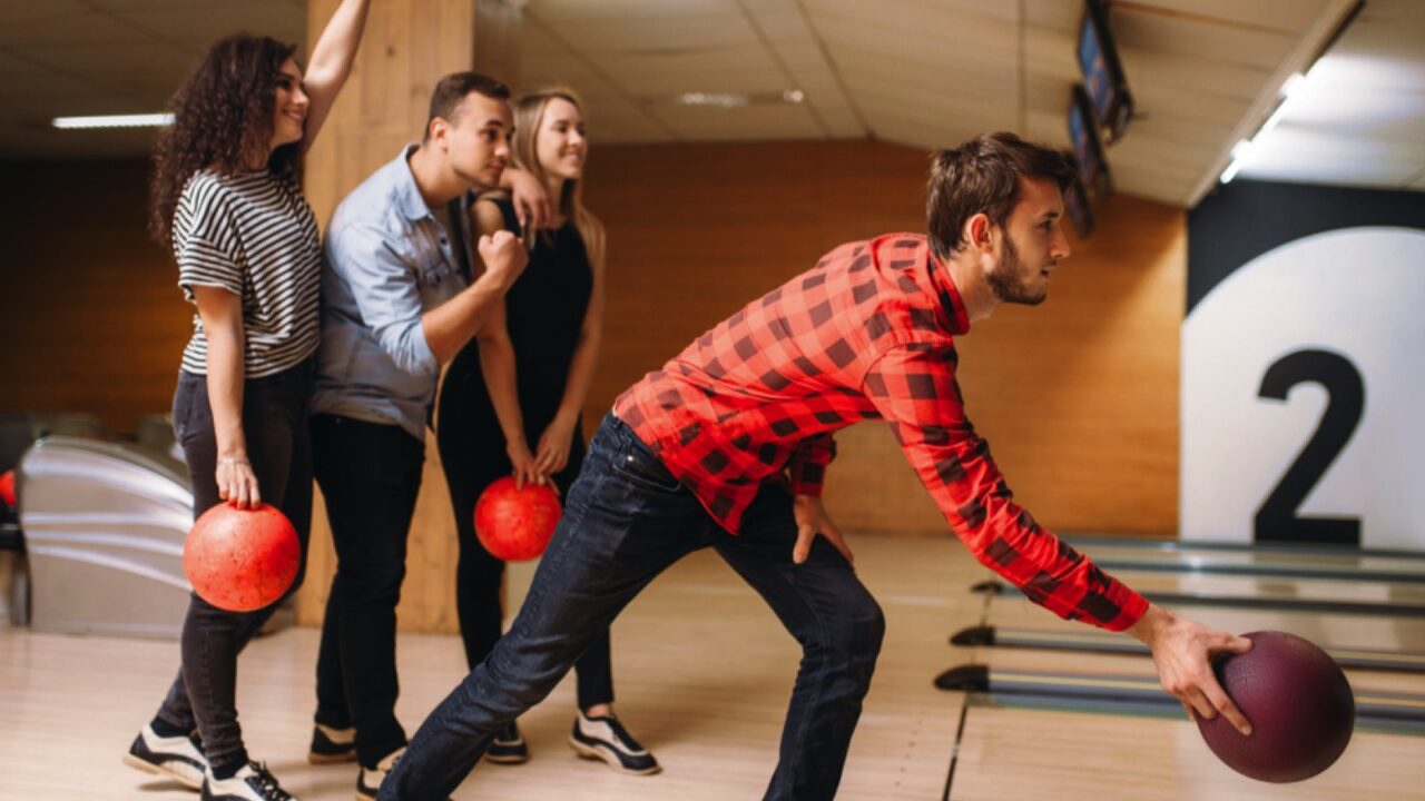 Man bowling with friends