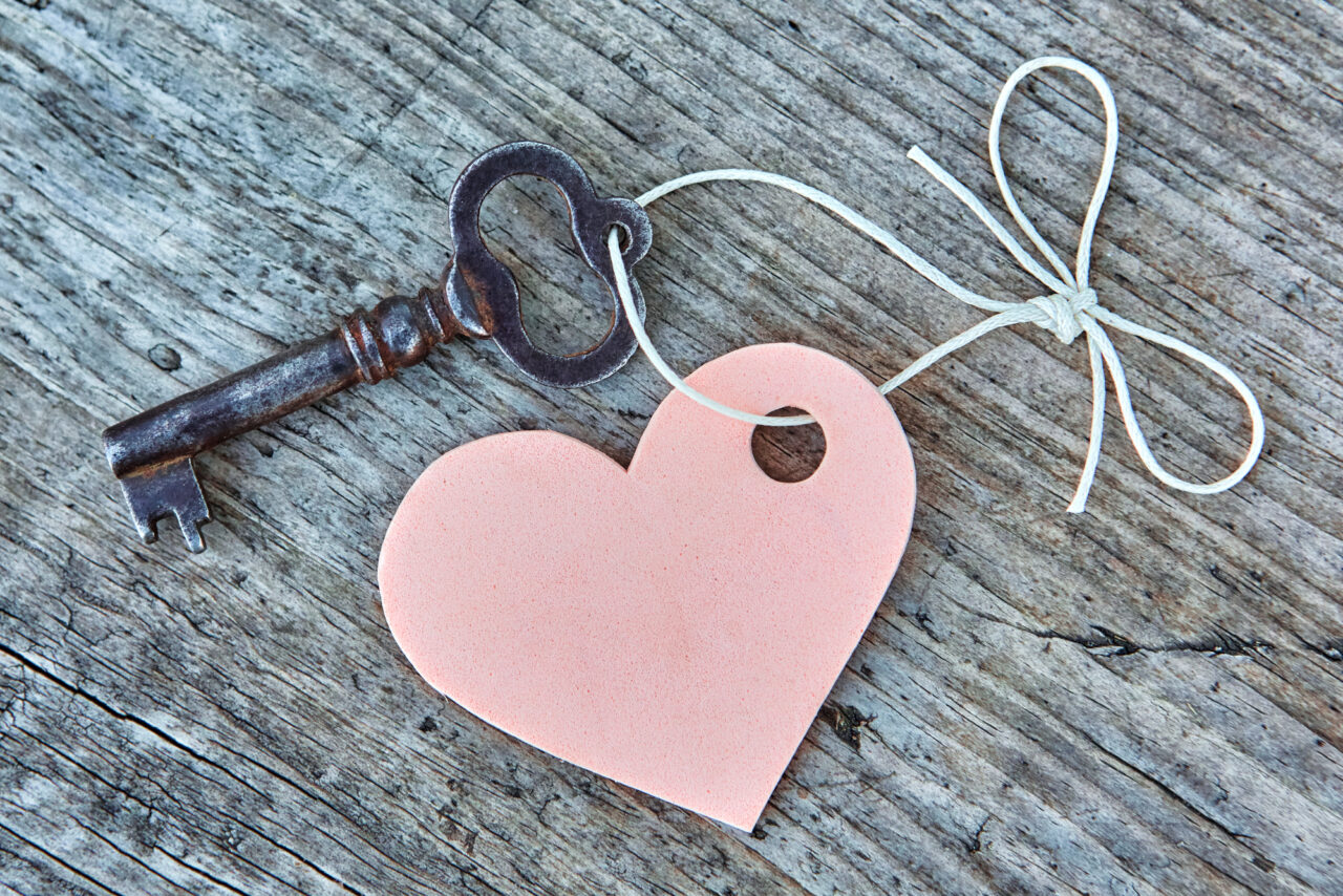 Vintage key and pink heart on a string with a bow. Valentine.