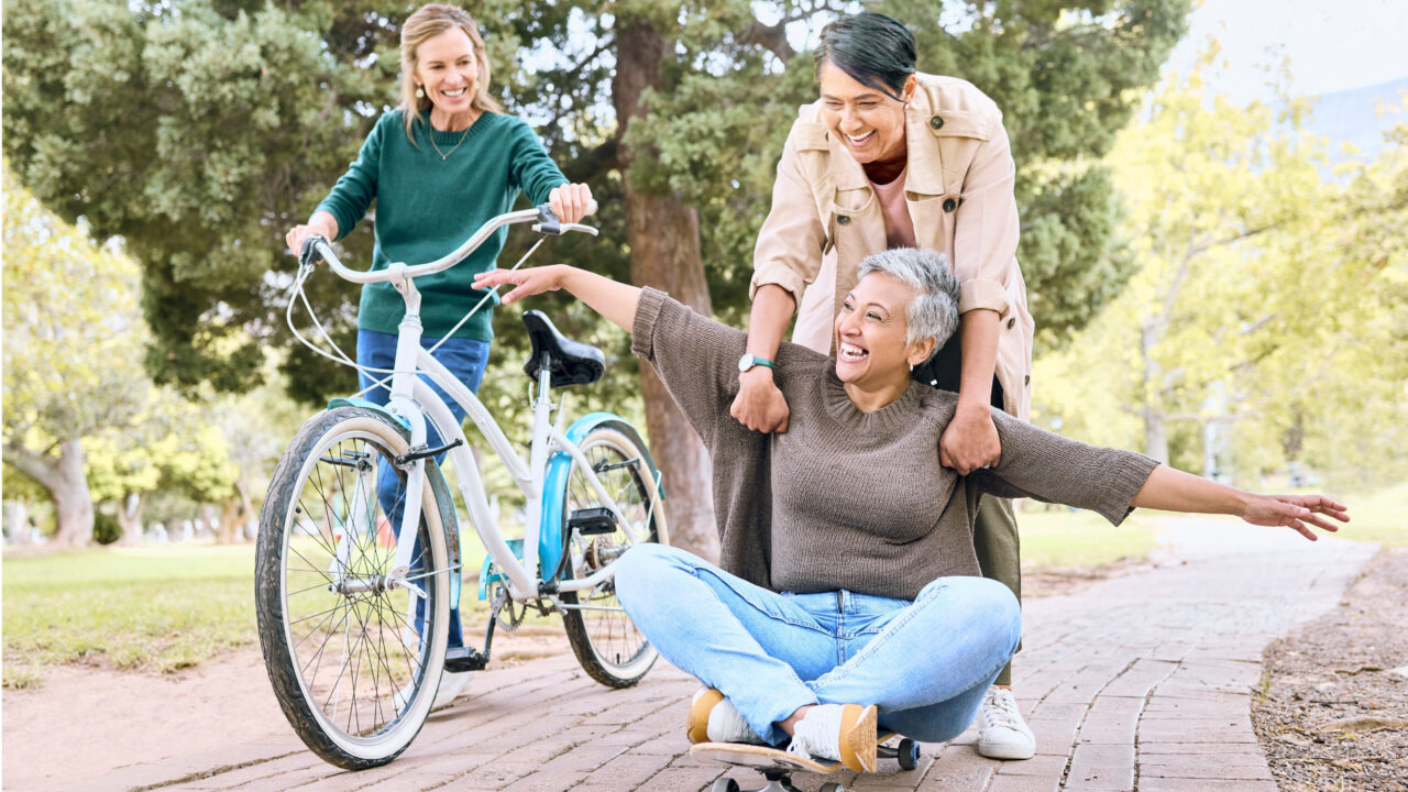 Three friends having fun with bike.