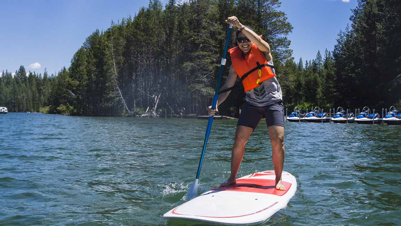 Person paddle boarding on sunny day