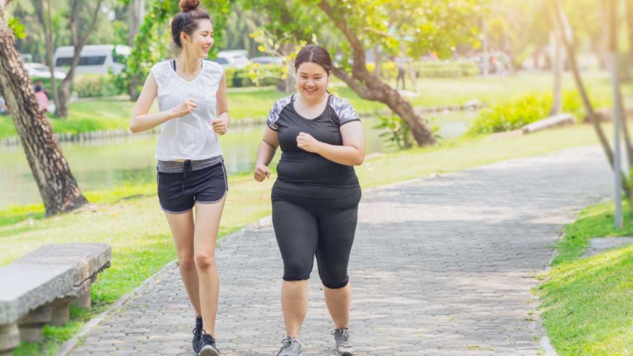 two teen friends on a jog together.