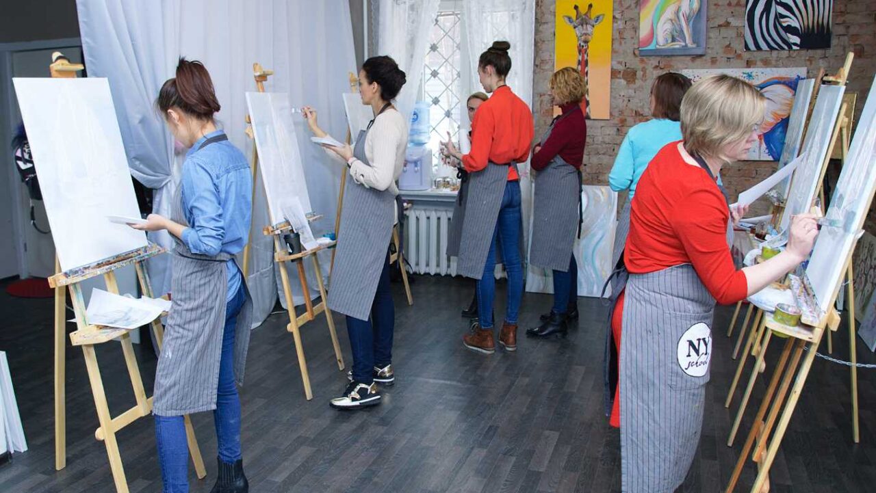 Adults at Art workshop. Master class in painting acrylic paint on canvas.